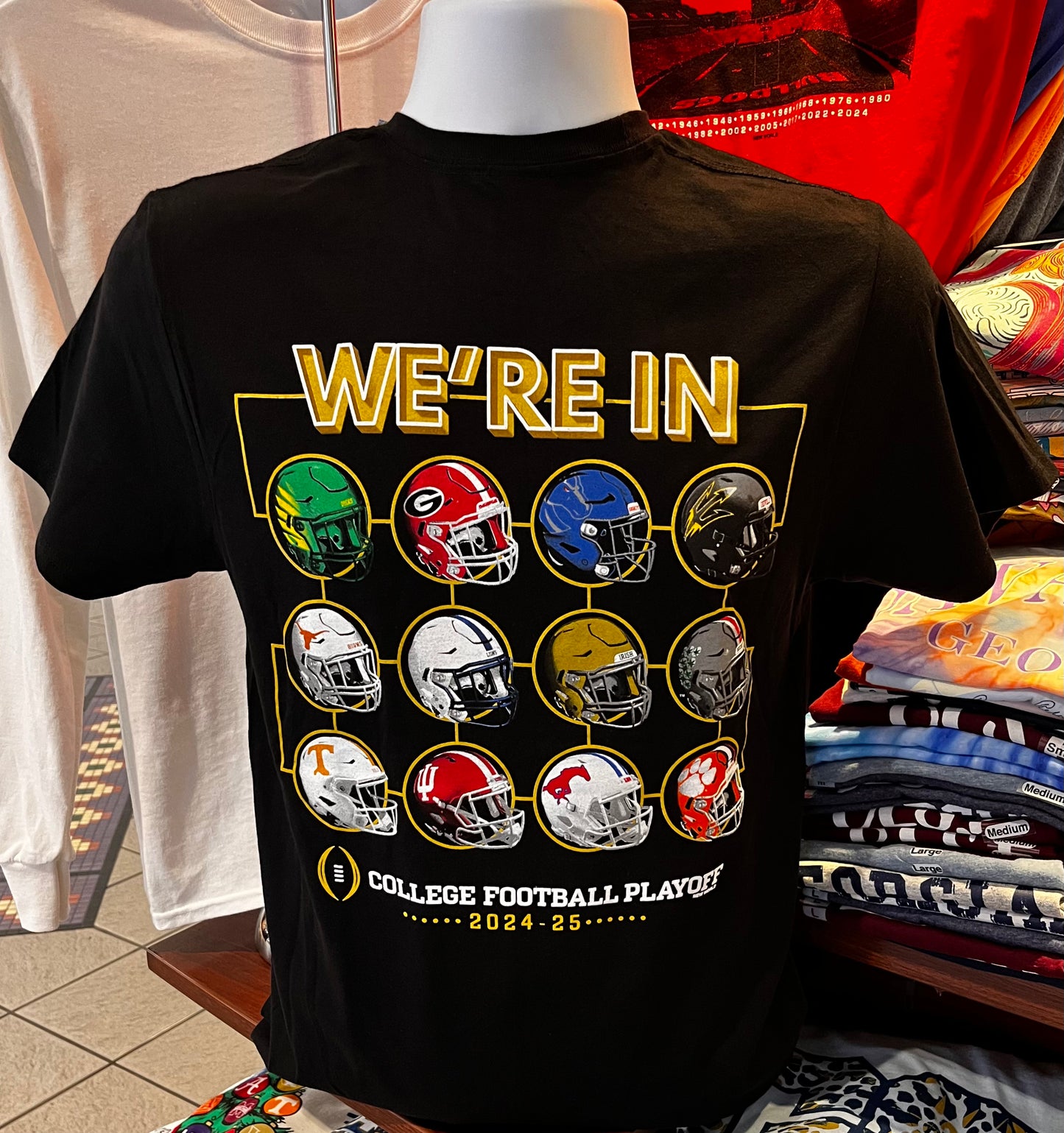 2024 12-Team College Football Playoffs T-shirt - “2024 CFP We’re In Team Helmets Tee” (Short Sleeve Black)