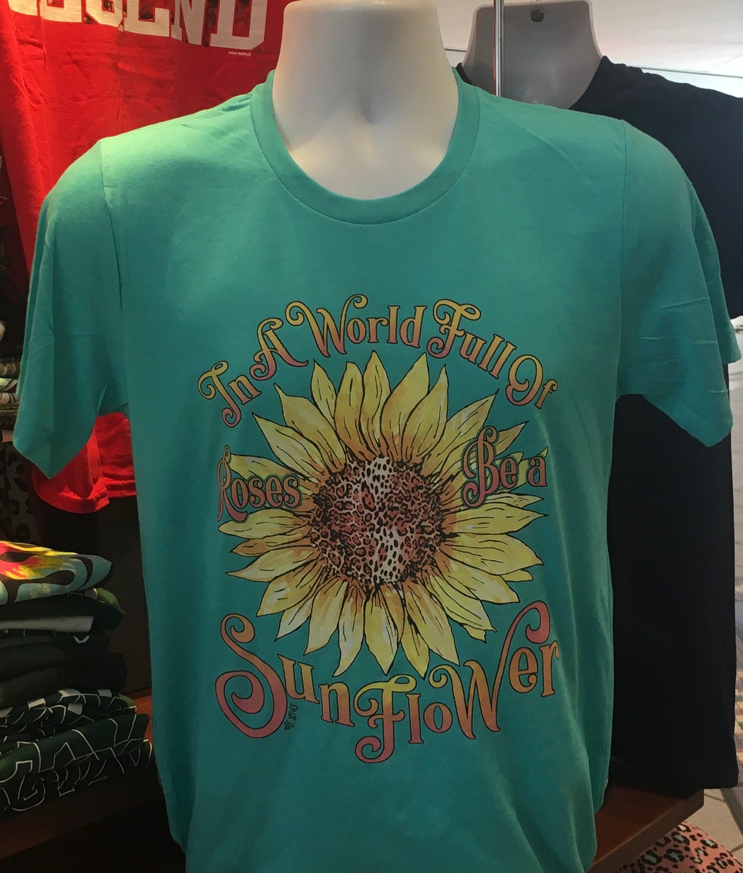 “In a world full of roses, be a sunflower” Short Sleeve (Turquoise)